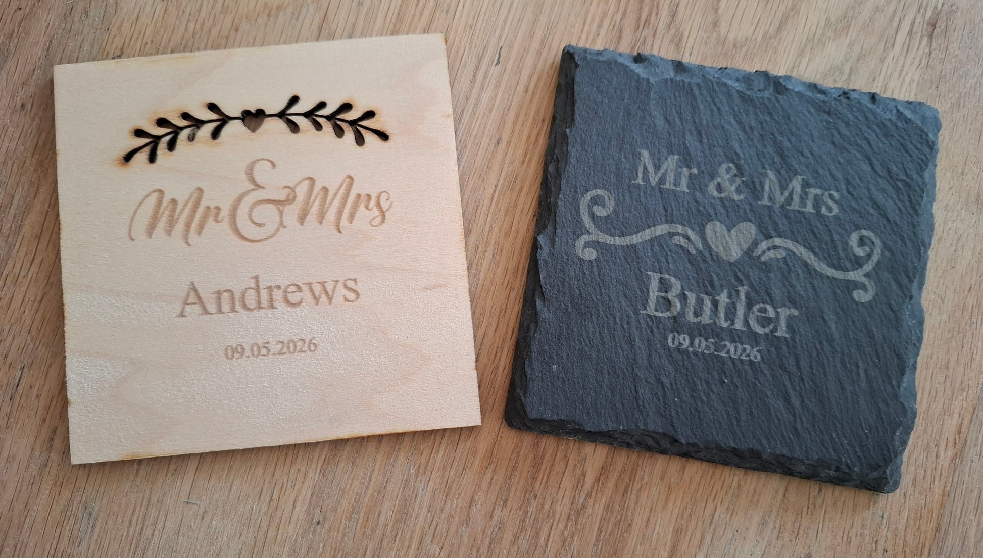 Wooden and slate coasters with engraved 'Mr & Mrs' names on a wooden surface